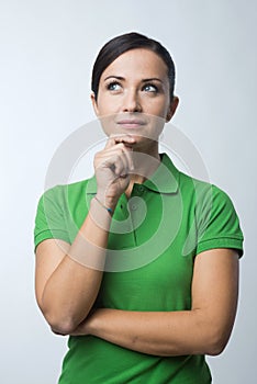 Smiling woman thinking with hand on chin