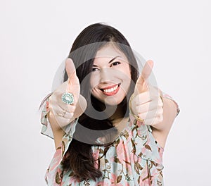 Smiling woman with thumbs up gesture