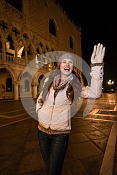 Smiling woman tourist handwaving to someone near Dogi Palace photo