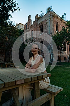 Smiling woman tourist near Saint Joseph Orphanage Istanbul Beyoglu. Ancient building In TomTom District