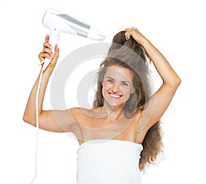 Smiling woman in towel blow-dry