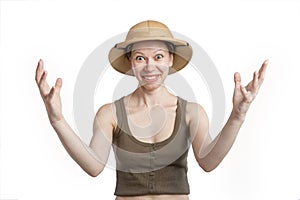 Smiling woman in a tropical helmet spreads his arms wide