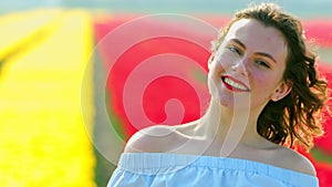 Smiling woman on tulips field