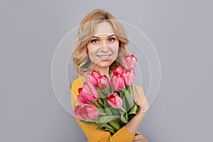 smiling woman with tulips. lady hold flowers for spring holiday. girl with bouquet