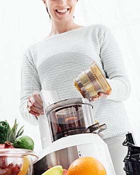 Woman using a juice extractor