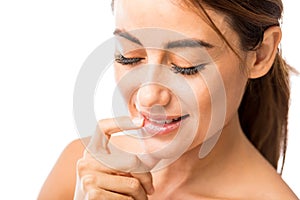 Smiling Woman Using Lip Cream