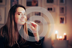 Smiling Woman Using an Orthodontic Transparent Silicone Teeth aligner at Night