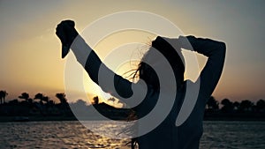 Smiling woman using phone camera on seaside. Beautiful girl posing at beach.