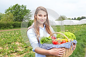 Smiling woman with vegetables fresh from the farm