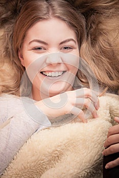 Smiling woman waking up on bed