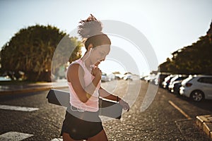 Smiling woman walking to her yoga class listening to music