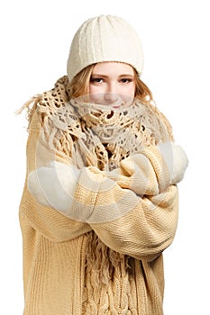 Smiling woman in warm clothing hugging herself