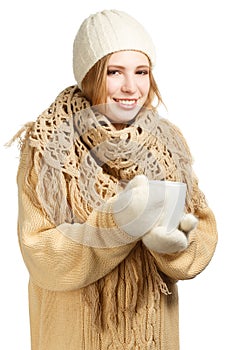 Smiling woman in warm clothing with mug