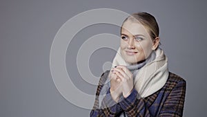 Smiling woman in warm coat and muffler