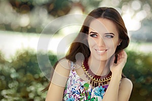 Smiling Woman Wearing Floral Dress and Big Necklace