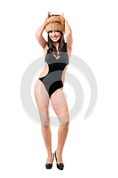 Smiling woman wearing swimsuit and fur-cap