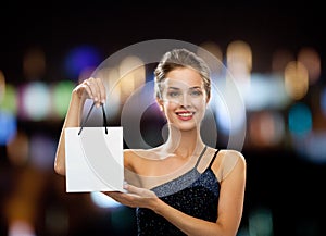 Smiling woman with white blank shopping bag