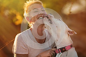 Smiling woman with white Dogo Argentino