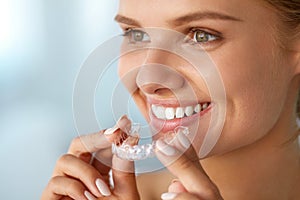 Smiling Woman With White Teeth Holding Teeth Whitening Tray