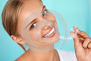 Smiling Woman With White Teeth Holding Teeth Whitening Tray