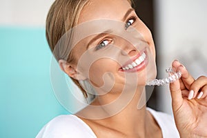 Smiling Woman With White Teeth Holding Teeth Whitening Tray