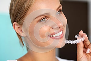 Smiling Woman With White Teeth Holding Teeth Whitening Tray