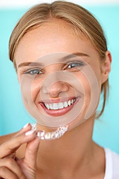 Smiling Woman With White Teeth Holding Teeth Whitening Tray