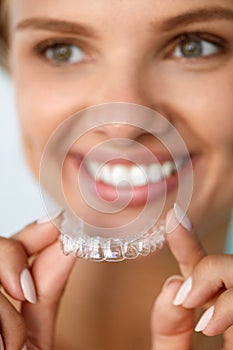 Smiling Woman With White Teeth Holding Teeth Whitening Tray