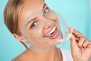 Smiling Woman With White Teeth Holding Teeth Whitening Tray