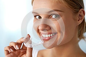 Smiling Woman With White Teeth Holding Teeth Whitening Tray