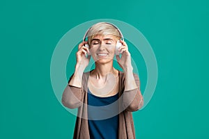 Smiling woman with wireless headphones, free space