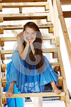 Smiling woman on wooden stairs