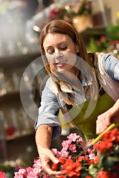 Smiling woman working in flower shop