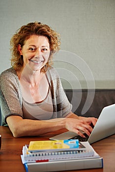 Smiling woman working from home on laptop