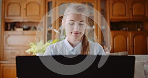 Smiling Woman Working on Laptop.