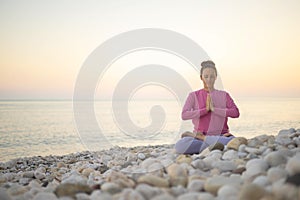 Smiling woman yoga meditation siddhasana lotus namaste hands sea sunset beach sky horizon landscape