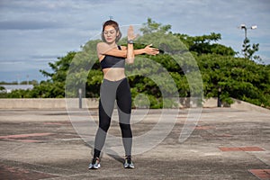 Smiling women asian runner doing stretching exercise, preparing for morning workout and lifestyle concept on city