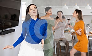 Smiling women dancing at a bachelorette party - girlfriends home party