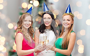 Smiling women holding glasses of sparkling wine