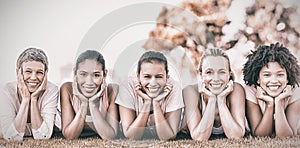 Smiling women lying in row for breast cancer awarness