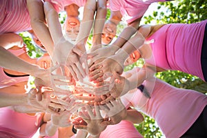 Smiling women organising event for breast cancer awareness