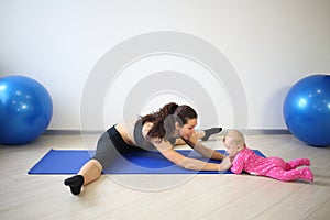 Smiling woman sitting on the splits leaned forward photo