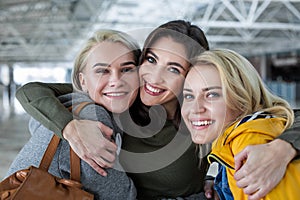 Smiling women standing in embrace