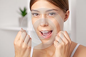 Smiling women use dental floss white healthy teeth