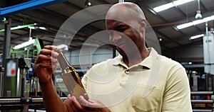 Smiling worker examining a bottle