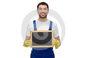 smiling worker or male cleaner showing chalkboard