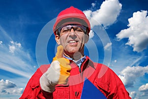 Smiling Worker Over Blue Sky and Clouds Background