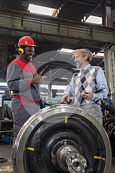 Smiling Worker In Protective Workwear And Smiling CEO Having A Relaxed Chat