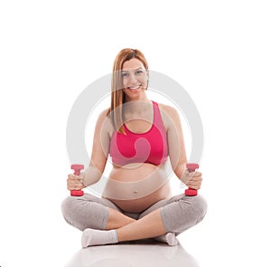 Smiling young adorable pregnant woman exercise