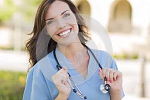 Smiling Young Adult Woman Doctor or Nurse Portrait Outside